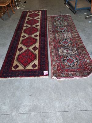 two rugs that are on the floor in a room