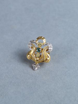 an image of a gold ring with a green and white stone