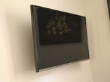 une photo d'une télévision à écran plat montée sur un mur
