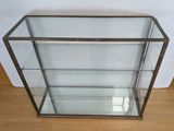 an image of a glass display case sitting on top of a hard wood floor