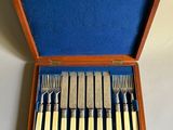 a wooden box with a set of silverware in it