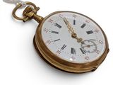 a gold pocket watch with roman numerals on it
