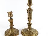 a pair of brass candlesticks with a bird on the base