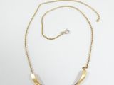 a gold and diamond necklace with a curved bar on a chain