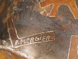 a close up of a vase with a brown design on it
