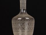 a clear glass bottle sitting on top of a wooden table