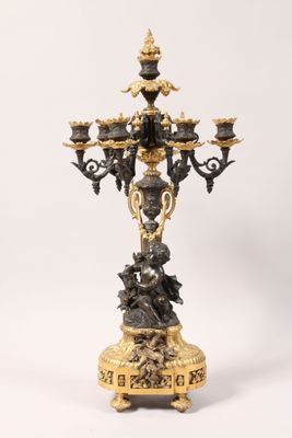 an antique bronze candelabra with a black and gold finish