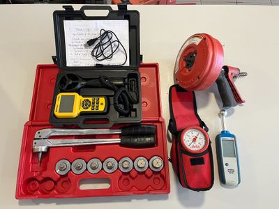 a red case with tools on it sitting on a table