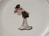 a plate with a picture of a woman holding a fan