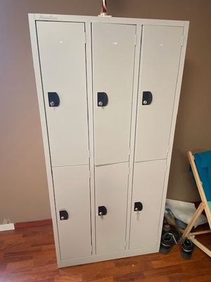 a picture of a white locker in a room with a blue chair