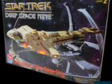 a box with a model of a space ship in it