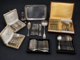 an assortment of silverware including spoons, forks, and a tray