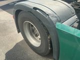 a truck with a flat tire parked on the side of the road