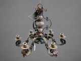 a chandelier with a bird on it hanging from the ceiling