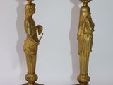 pair of antique brass candlesticks with figures on them