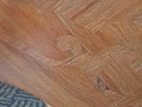a close up of a wooden table with a clock on it