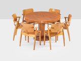 an image of a round dining table with six chairs around it