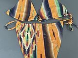 a close up of a bikini top with a tie around the bottom