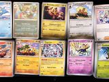 several pokemon cards are lined up on a black surface