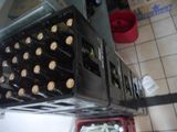 bottles of beer are stacked on top of each other in a kitchen