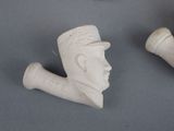 a small statue of a man with a pipe next to it