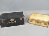 two suitcases sitting next to each other on a table