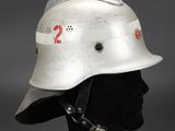 an old fireman ' s helmet on a mannequin head