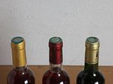 three bottles of wine that are sitting on a table
