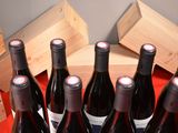 several bottles of wine are lined up in a row on a table