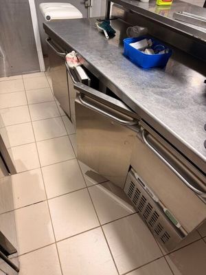 a kitchen with a sink, stove, and dishwasher in it