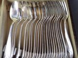 a lot of silver spoons and spoons in a box