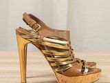 an image of a pair of high heeled sandals on a wooden table