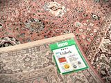 a carpet with a tag on it on the floor