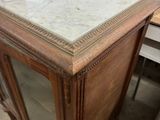 a marble top cabinet with a glass door on it