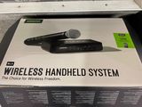 a box with a microphone on top of it on the floor