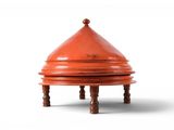 an image of a small red vase sitting on top of a wooden stand
