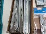 a box of metal parts on a table next to other items