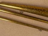 three brass trumpets sitting on top of a table next to each other