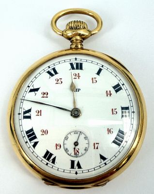 a gold pocket watch with roman numerals on the face