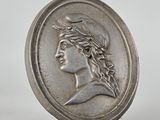 a close up of a coin with a woman ' s face on it