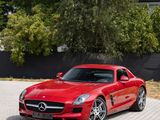 two red sports cars are parked in front of a house