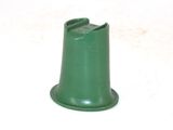 a green plastic cone on a white surface