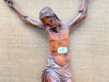 a statue of jesus on the cross on a burlock cloth