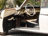 a white car with the door open sitting on the street