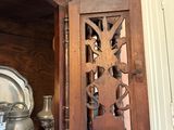 a wooden cabinet with a mirror on the top of it