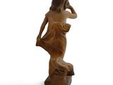 statue of a woman standing on a rock with her hand on her head