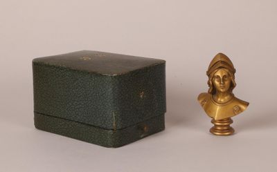 an image of a small statue of a woman next to a box