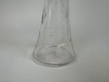a clear glass vase with a flower inside of it
