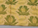 an image of a piece of cloth with green and yellow flowers on it