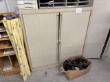a box of shoes in front of a cabinet in a garage
